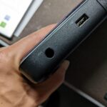 Close-up of a laptop charging port showing a damaged center pin inside a traditional DC power jack.